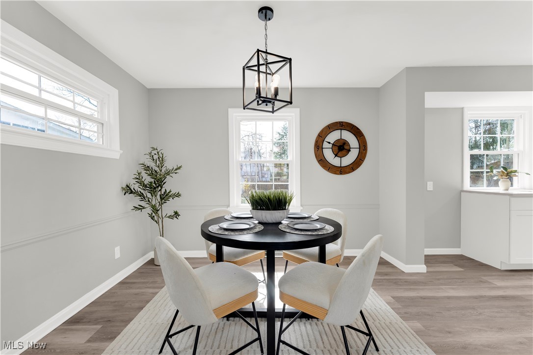 3964 Navahoe Road Cleveland Heights, OH 44121 - Photo 12 of 30 Dining space featuring a wealth of natural light, a notable chandelier, and light wood-type flooring
