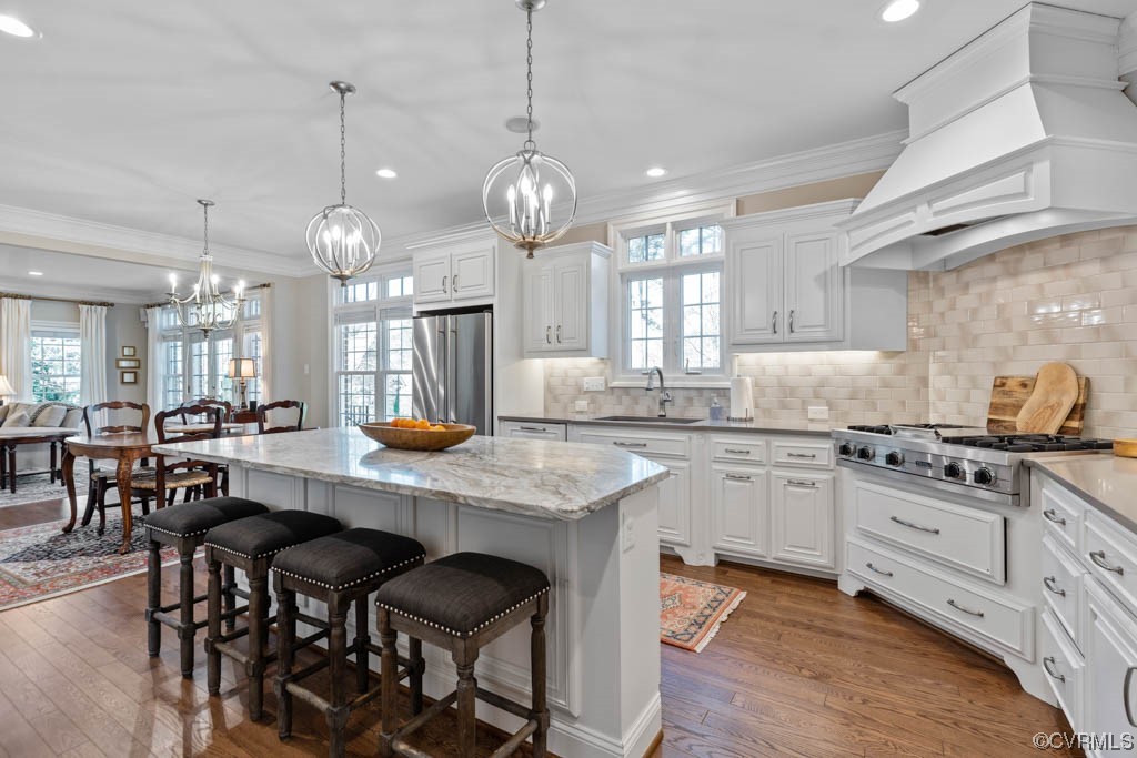 2436 Founders Bridge Road Midlothian, VA 23113 - Photo 15 of 45 a kitchen with stainless steel appliances granite countertop a stove a sink a dining table and chairs with wooden floor