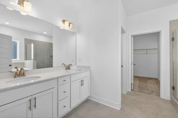 a white bath tub sitting next to a shower
