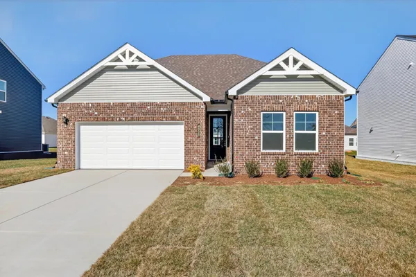 a view of a house with a yard and garage