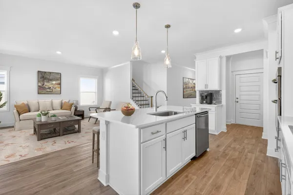 a large room with kitchen island a sink a window and a couch