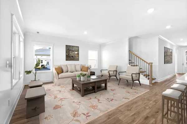 a living room with furniture wooden floor and a table