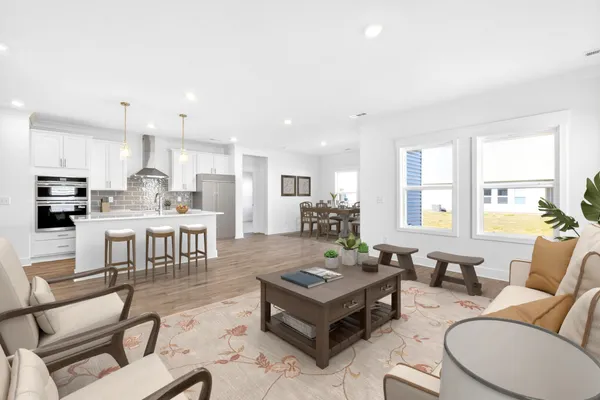 a living room with furniture and kitchen view