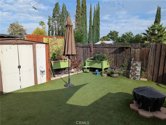 a view of backyard with trampoline
