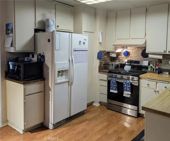 a kitchen with stainless steel appliances a refrigerator stove and sink
