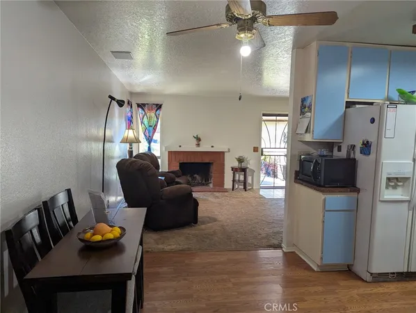 a living room with furniture and kitchen view