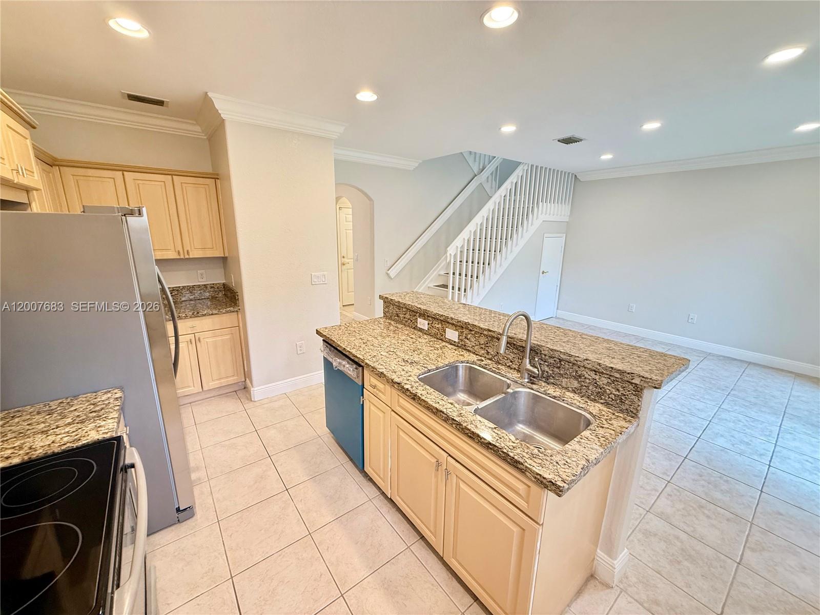 2674 Southwest 84th Terrace, Unit 102 Miramar, FL 33025 - Photo 12 of 57 a kitchen with stainless steel appliances granite countertop a sink and a stove