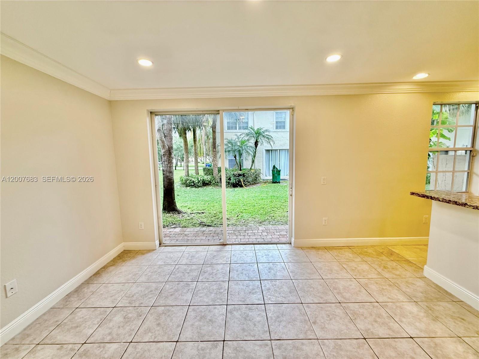 2674 Southwest 84th Terrace, Unit 102 Miramar, FL 33025 - Photo 16 of 57 a view of an empty room with a fireplace and a floor to ceiling window