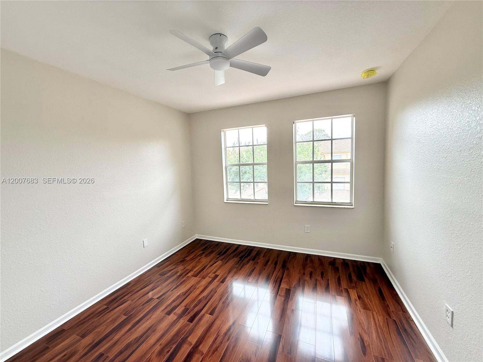2674 Southwest 84th Terrace, Unit 102 Miramar, FL 33025 - Photo 23 of 57 an empty room with wooden floor windows and fan