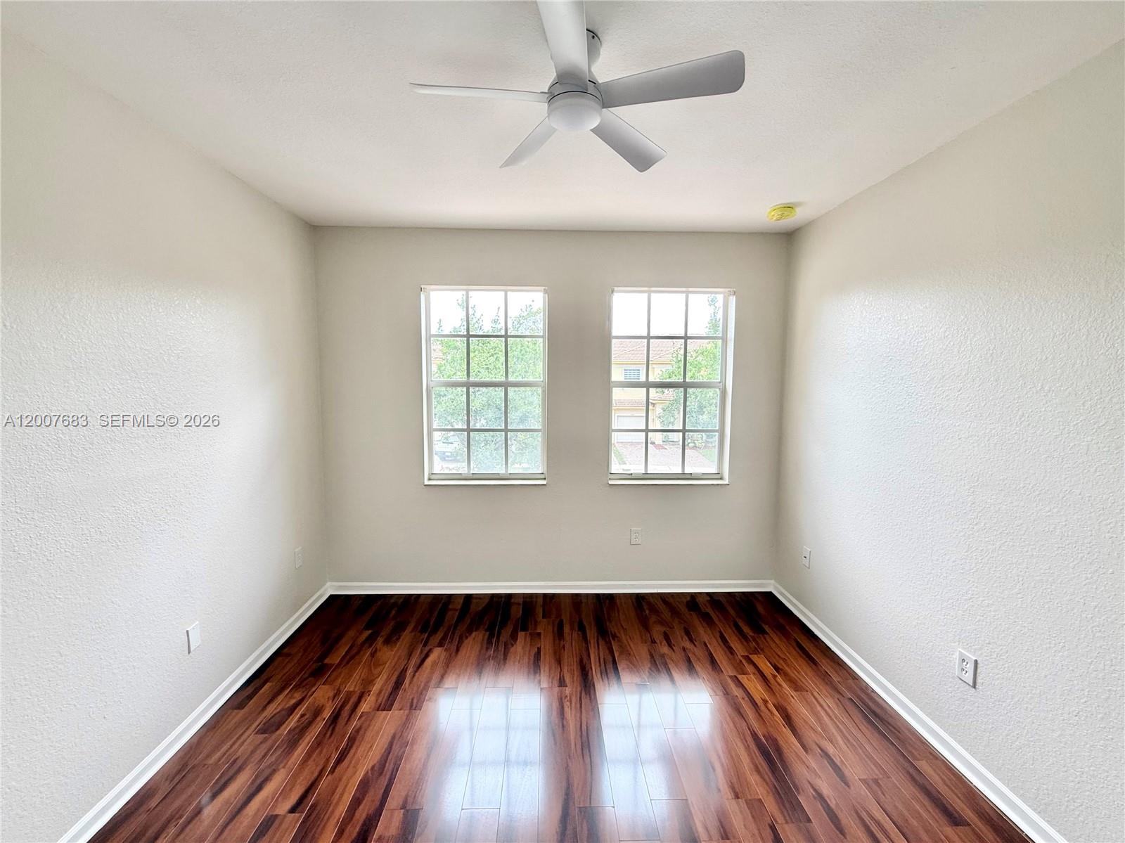 2674 Southwest 84th Terrace, Unit 102 Miramar, FL 33025 - Photo 24 of 57 an empty room with wooden floor and windows