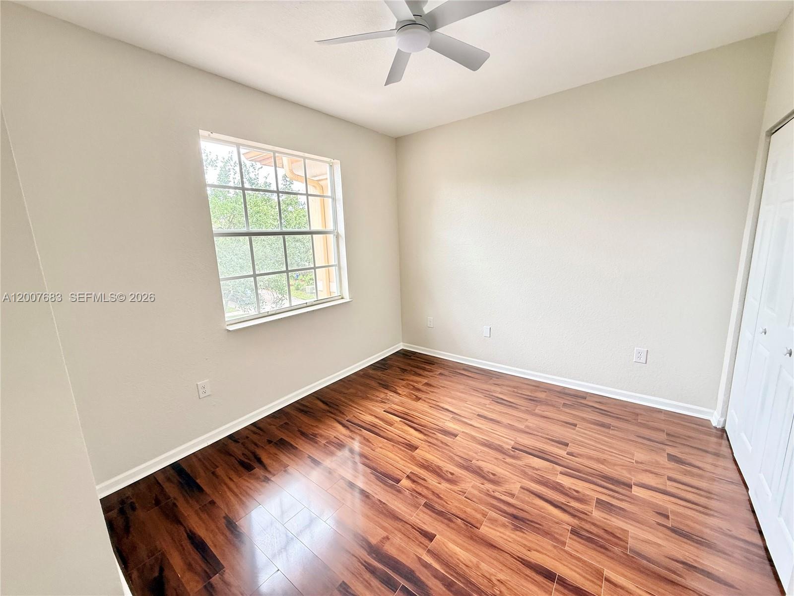 2674 Southwest 84th Terrace, Unit 102 Miramar, FL 33025 - Photo 25 of 57 an empty room with wooden floor fan and windows