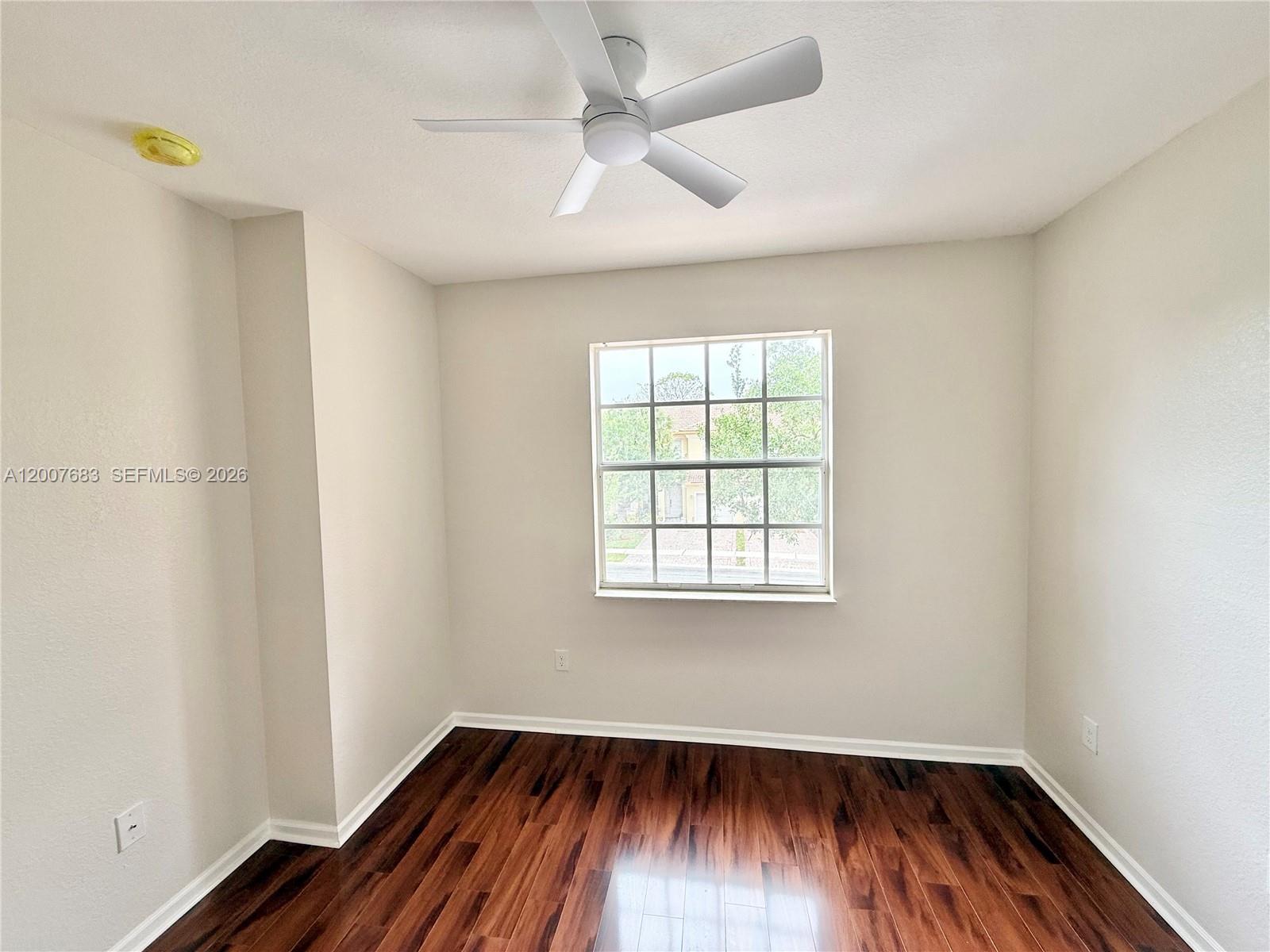 2674 Southwest 84th Terrace, Unit 102 Miramar, FL 33025 - Photo 26 of 57 wooden floor in an empty room with a window