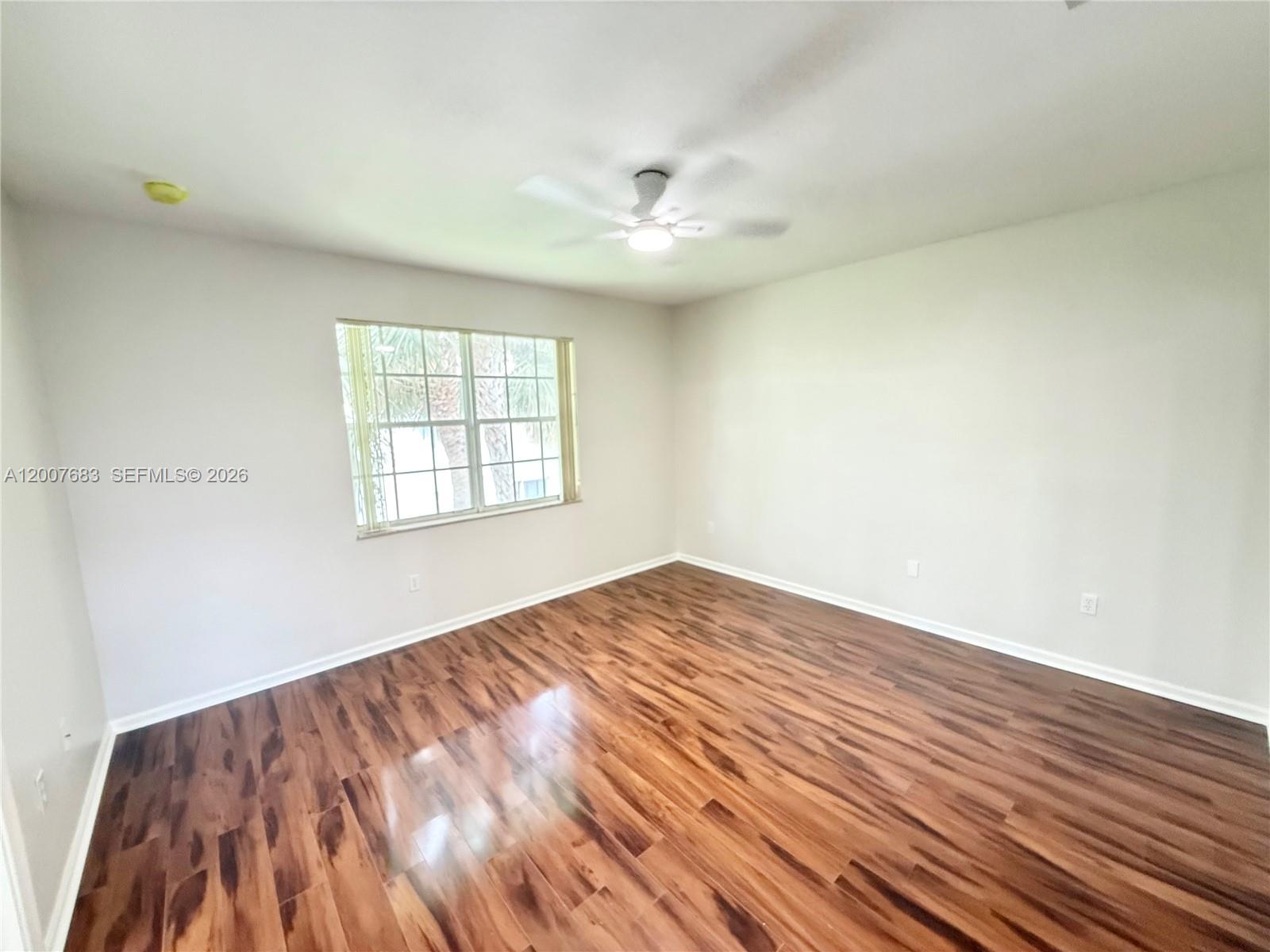 2674 Southwest 84th Terrace, Unit 102 Miramar, FL 33025 - Photo 35 of 57 a view of empty room with wooden floor and fan