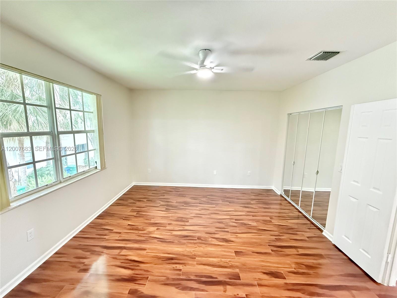 2674 Southwest 84th Terrace, Unit 102 Miramar, FL 33025 - Photo 36 of 57 wooden floor in an empty room with a window