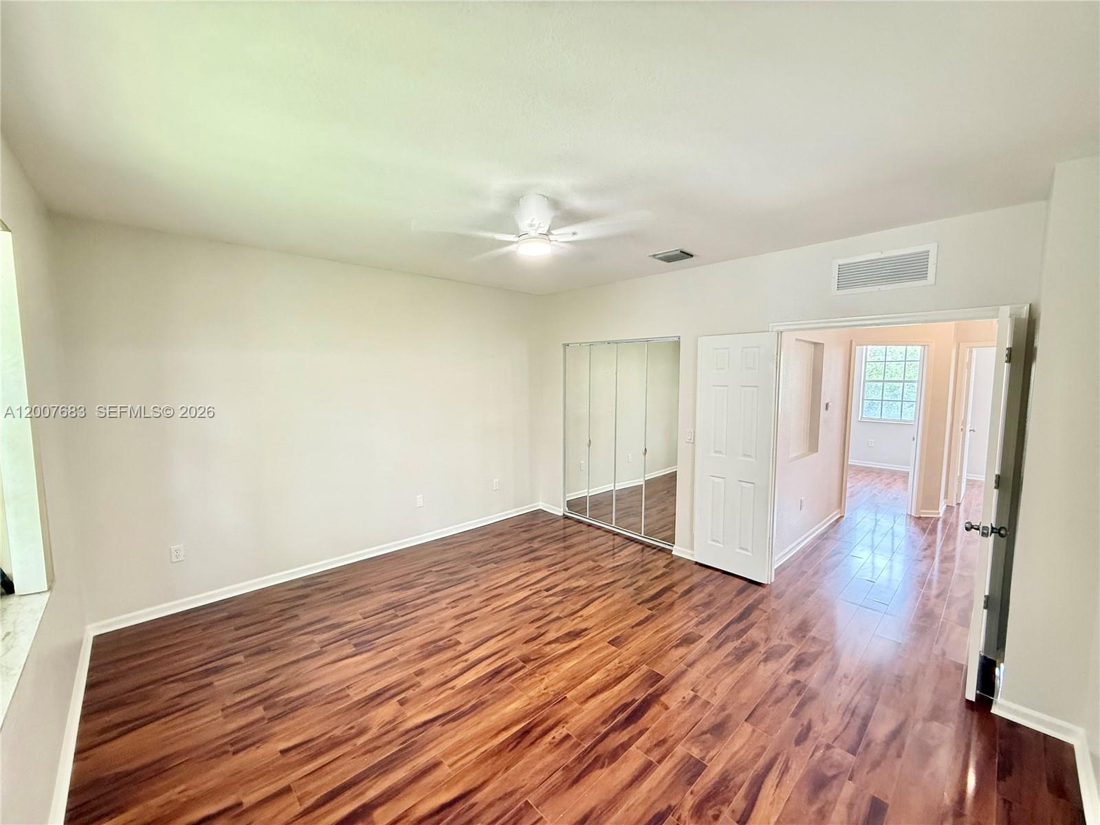 2674 Southwest 84th Terrace, Unit 102 Miramar, FL 33025 - Photo 37 of 57 a view of empty room with wooden floor and fan