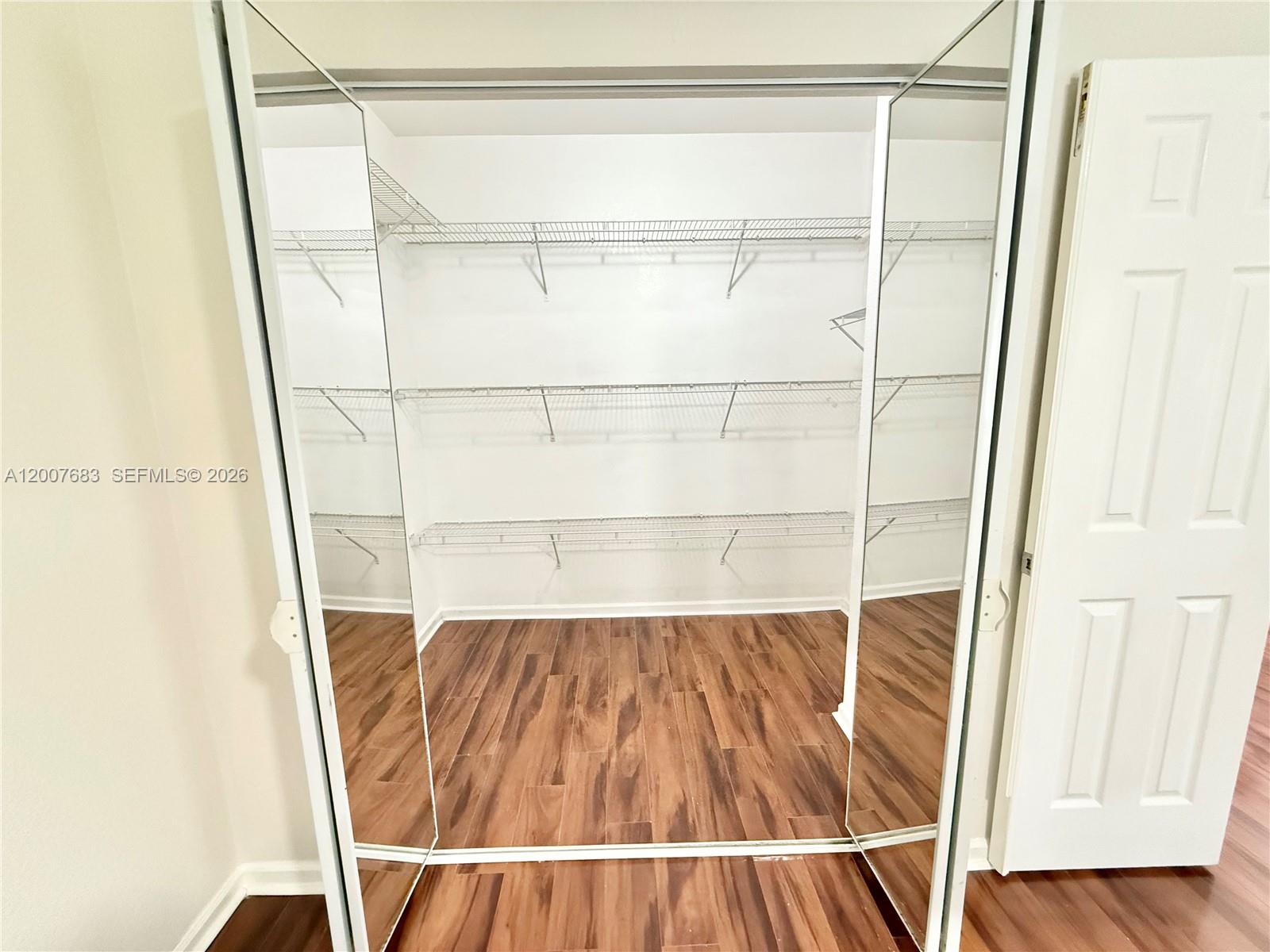 2674 Southwest 84th Terrace, Unit 102 Miramar, FL 33025 - Photo 38 of 57 a view of walk in closet with wooden floor