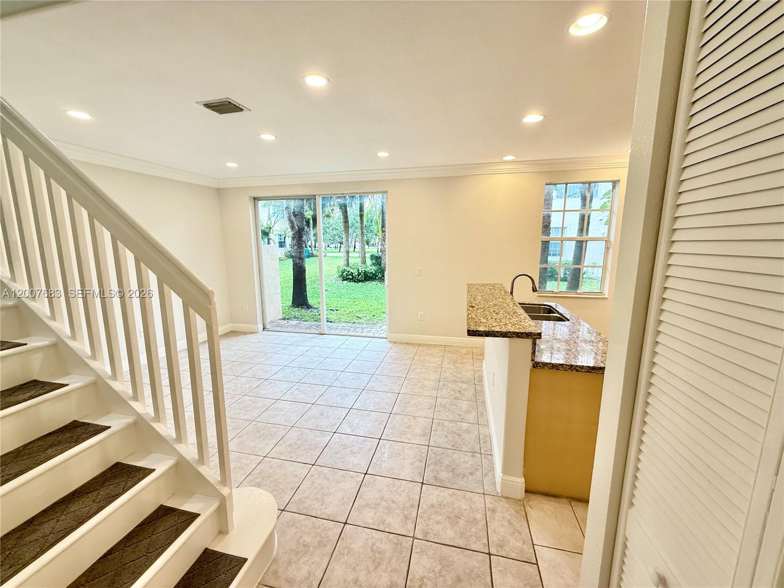 2674 Southwest 84th Terrace, Unit 102 Miramar, FL 33025 - Photo 4 of 57 a view of a hallway with wooden floor and staircase