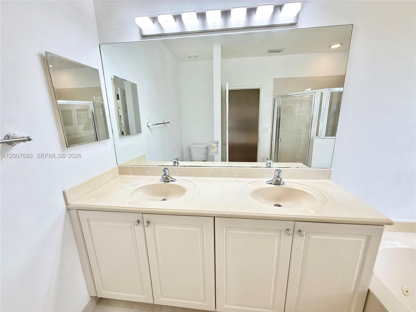 2674 Southwest 84th Terrace, Unit 102 Miramar, FL 33025 - Photo 42 of 57 a bathroom with a sink and a mirror