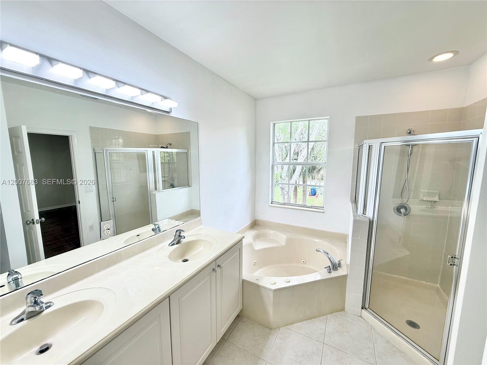 2674 Southwest 84th Terrace, Unit 102 Miramar, FL 33025 - Photo 43 of 57 a bathroom with a tub sink double and mirror