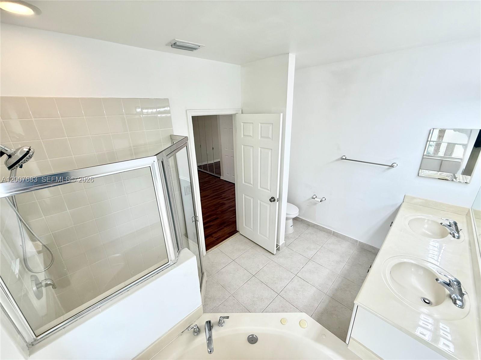 2674 Southwest 84th Terrace, Unit 102 Miramar, FL 33025 - Photo 45 of 57 a bathroom with a bathtub and a shower