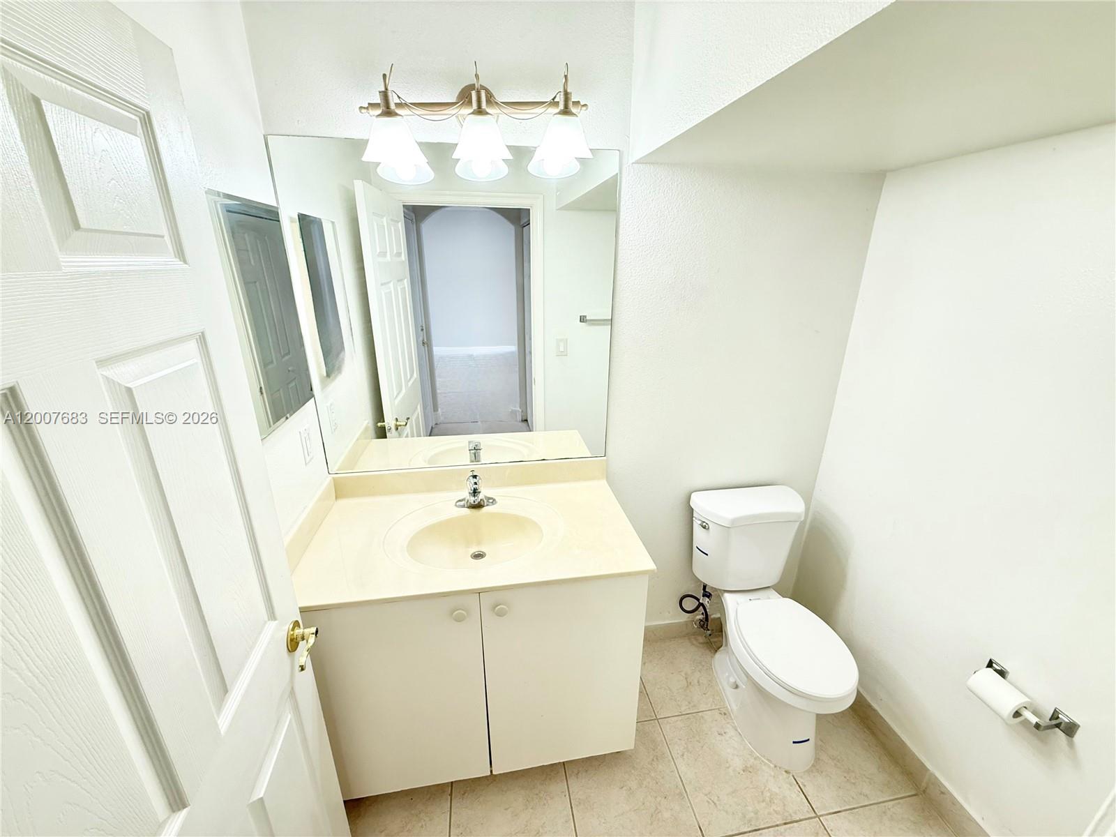 2674 Southwest 84th Terrace, Unit 102 Miramar, FL 33025 - Photo 49 of 57 a bathroom with a sink a toilet and mirror