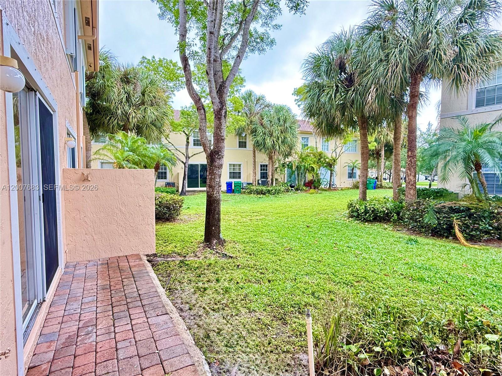 2674 Southwest 84th Terrace, Unit 102 Miramar, FL 33025 - Photo 54 of 57 a view of a backyard with palm trees