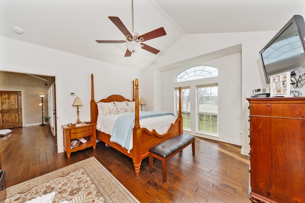 4460 Hildreth Pool Road Bowie, TX 76230 - Photo 15 of 40 a bedroom with a bed and wooden floor