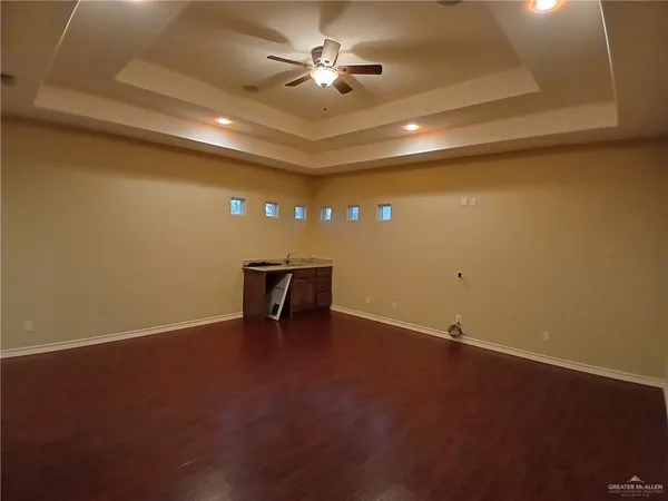 an empty room with projector and fan