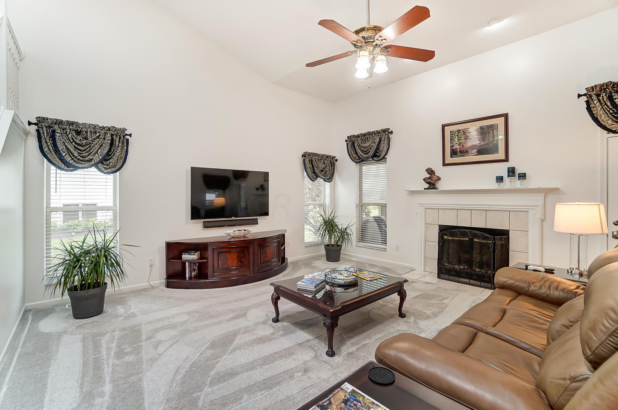 5674 Steward Road Galena, OH 43021 - Photo 34 of 82 Soaring ceilings & open feel, the family room has that cozy feel with gas log fireplace.