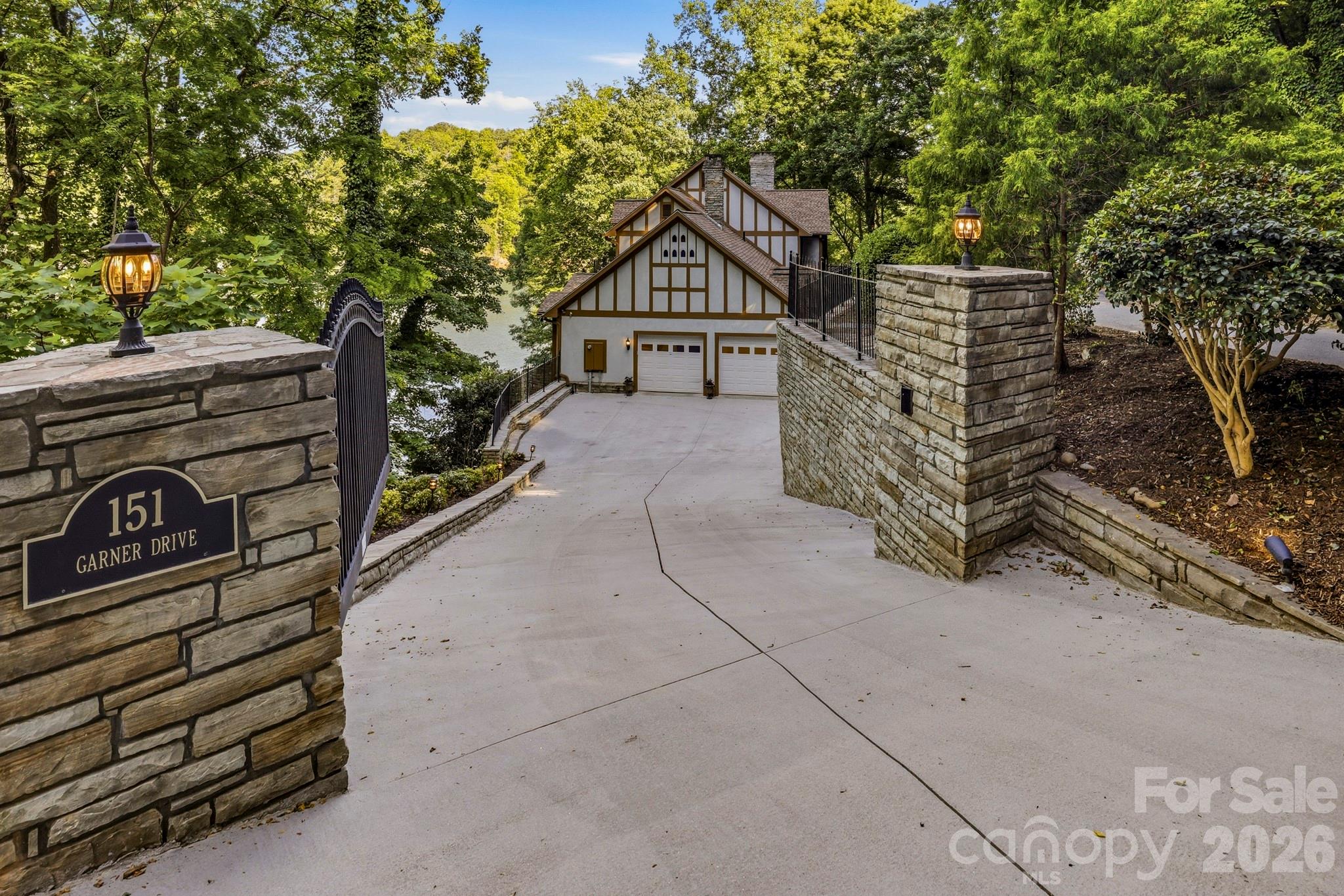 151 Garner Road Lake Lure, NC 28746 - Photo 3 of 48 a view of a house with a yard and wooden fence