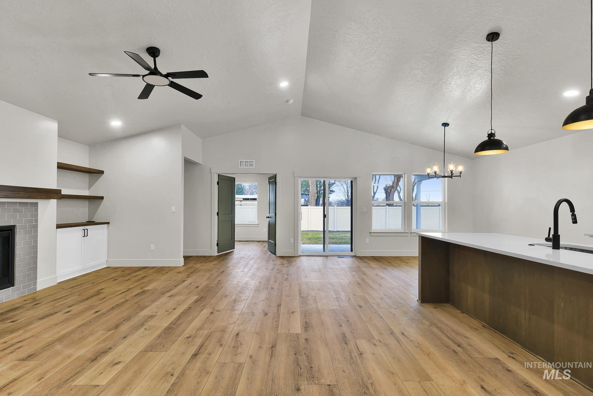 1130 Velvet Loop Wilder, ID 83676 - Photo 3 of 35 Open-concept living space featuring wood-finish flooring, vaulted ceilings, and recessed lighting