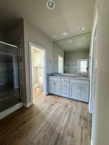 a view of an empty room and wooden floor