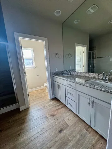 a view of a room with wooden floor and a window