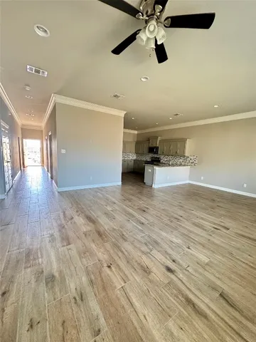 a kitchen with kitchen island granite countertop a stove top oven sink and cabinets