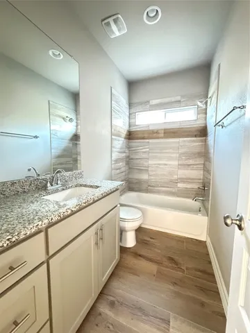 an empty room with wooden floor and window