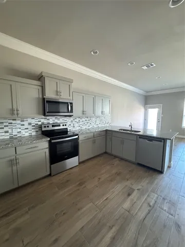 a kitchen with stainless steel appliances a stove sink and cabinets