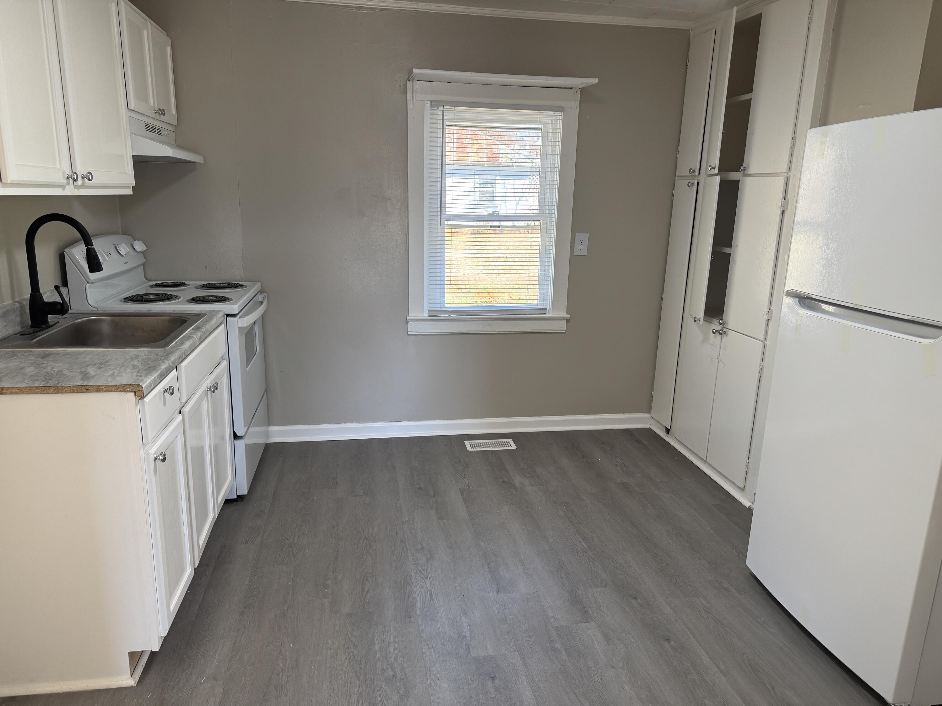 705 Barrows Mill Road Martinsville, VA 24112 - Photo 5 of 7 a kitchen with a refrigerator sink and cabinets