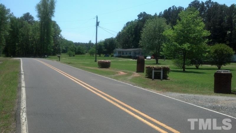 1135 B Lawrence Road Creedmoor, NC 27522 - Photo 11 of 13 a view of a stadium that has a street sign on a road