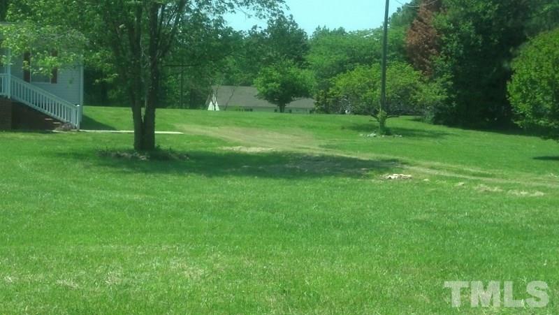 1135 B Lawrence Road Creedmoor, NC 27522 - Photo 13 of 13 a view of a grassy field with trees