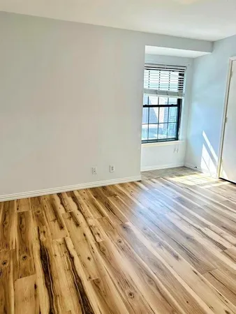 a view of wooden floor and windows in a room