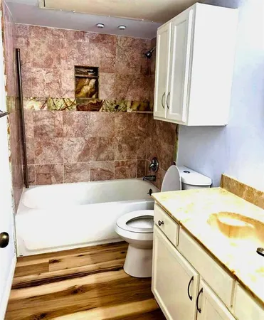 a bathroom with a sink a toilet and bathtub