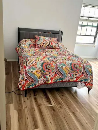 a bed sitting in a bedroom next to a window
