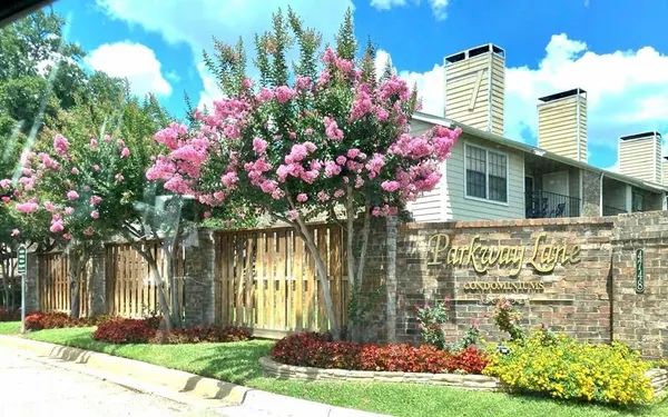 a front view of a house with a yard and fountain