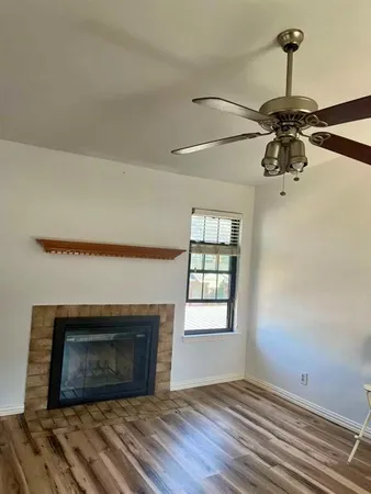 a view of empty room with a fireplace