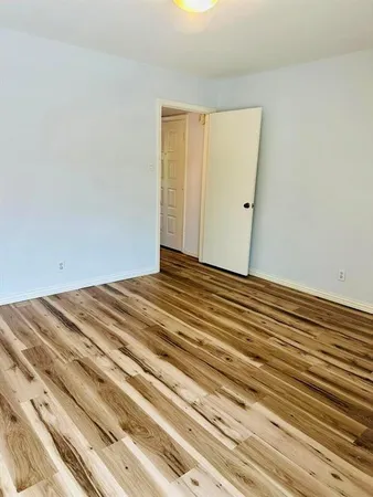 a view of a room with wooden floor