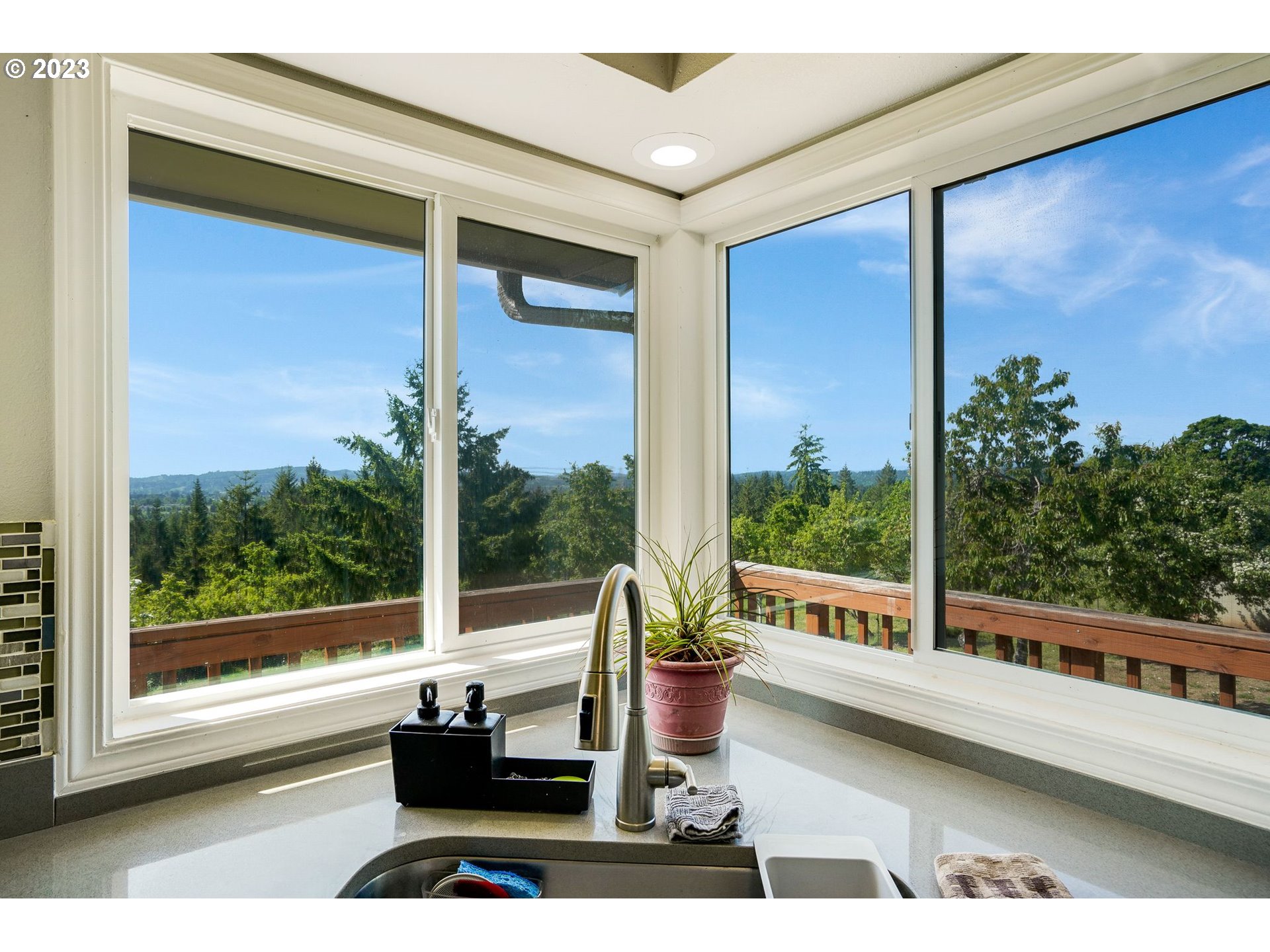 14410 Orchard Knob Road Dallas, OR 97338 - Photo 4 of 48 a view of a balcony with floor to ceiling windows with wooden floor