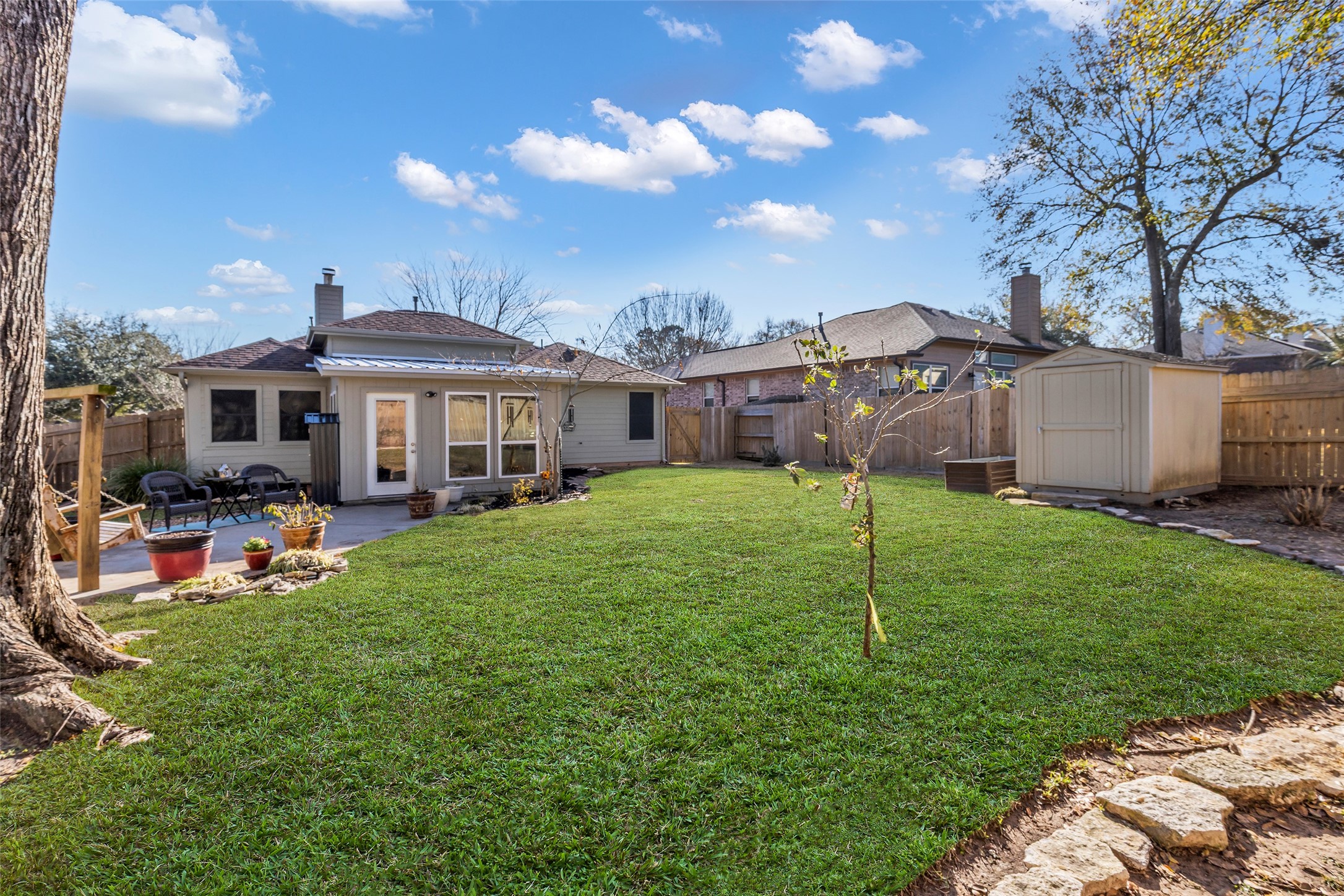 242 Sunset Path North Conroe, TX 77316 - Photo 33 of 37 Big yard, added sunroom with charming and durable metal roof. Hard to find outdoor space at this price point! 242 SUNSET PATH N - Request your tour today!