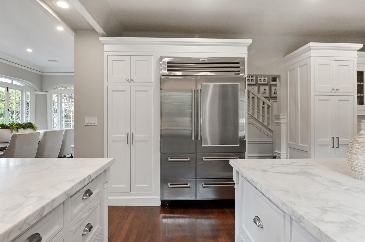 224 Warren Road San Mateo, CA 94402 - Photo 11 of 36 a kitchen with stainless steel appliances kitchen island granite countertop a refrigerator and a stove top oven