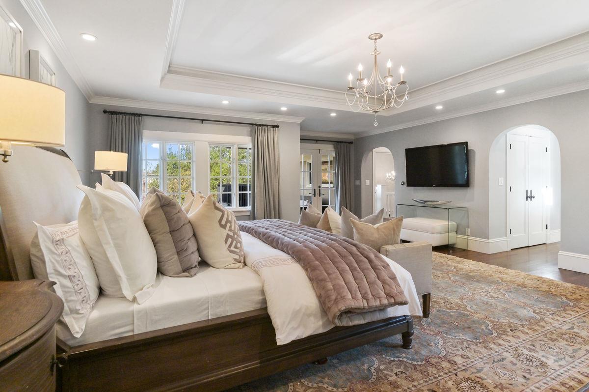 224 Warren Road San Mateo, CA 94402 - Photo 17 of 36 a spacious bedroom with a large bed and a flat screen tv