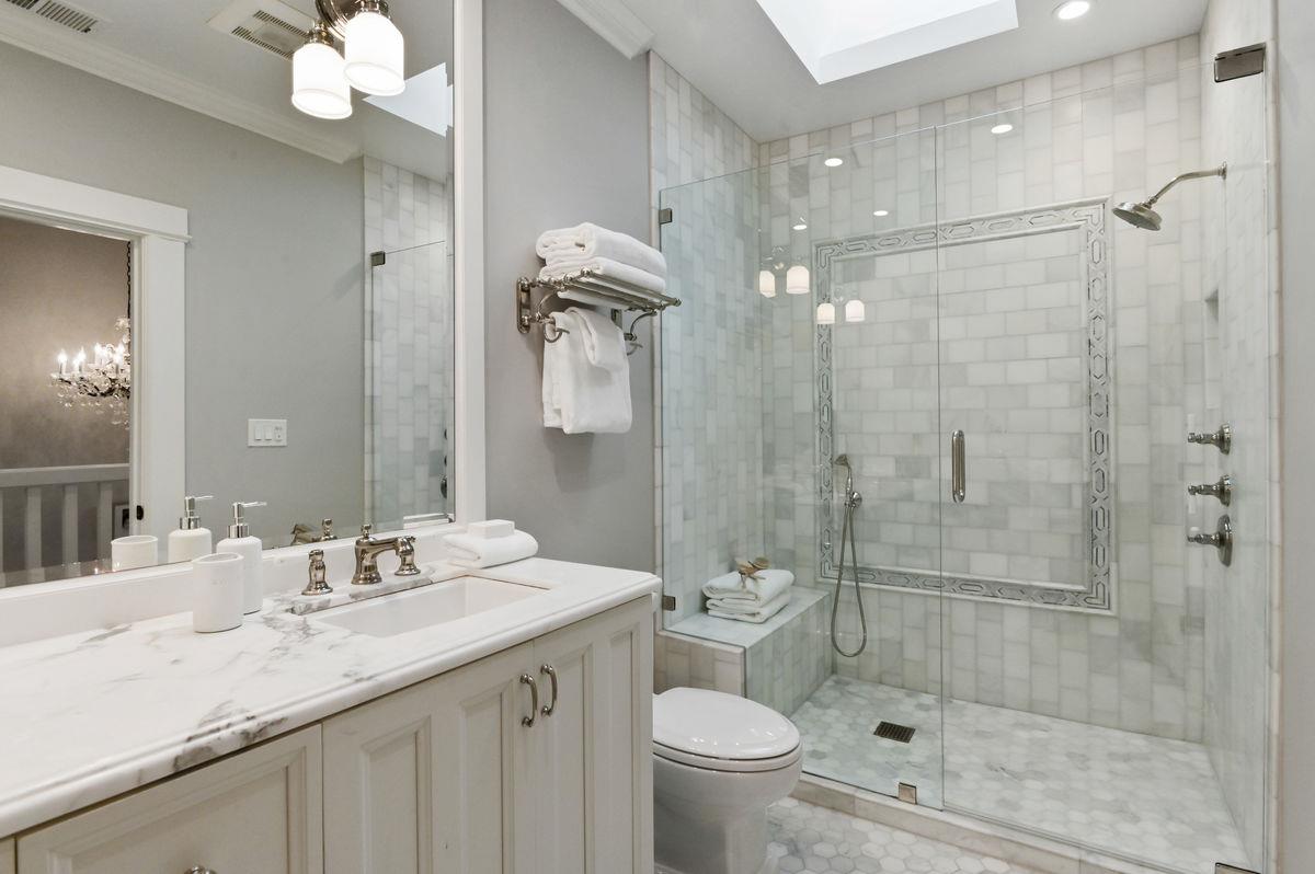 224 Warren Road San Mateo, CA 94402 - Photo 24 of 36 a bathroom with a granite countertop sink a toilet and shower